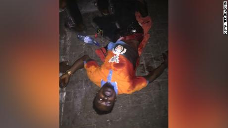 One of the protesters, Mathew, pictured, says he was injured when the army opened fire at Lekki toll gate. Using metadata, CNN geolocated the image to the protest location at 6:50 pm.