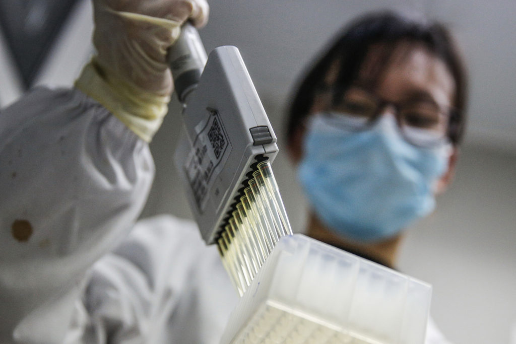A staff member tests samples of inactivated Covid-19 vaccine at a Sinovac Biotech lab in Beijing on March 16.