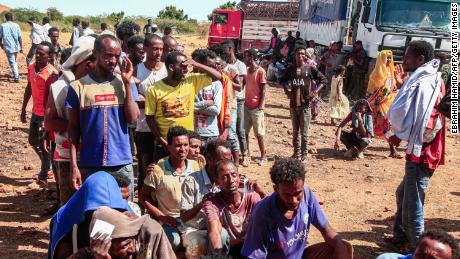 Ethiopian refugees fleeing Tigray line up to receive supplies at the Um Rakuba camp in Sudan&#39;s eastern Gedaref province, on November 16, 2020.