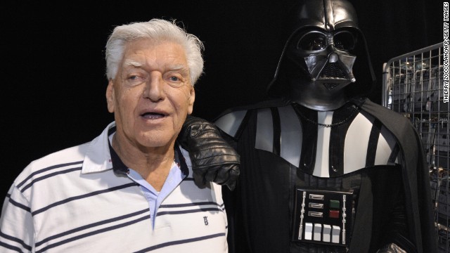 David Prowse poses with a fan dressed up in a Darth Vader costume during a &quot;Star Wars&quot; convention on April 27, 2013 in Cusset, France.