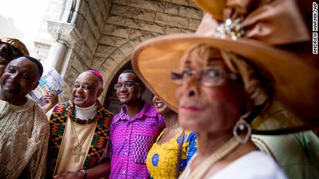 Archbishop Wilton Gregory, second from left, greets parishioners following mass at St. Augustine Church in Washington on June 2, 2019. 