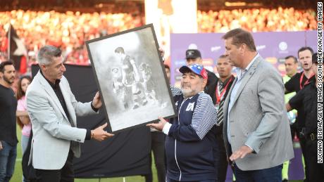 Diego Maradona was presented with painting of himself playing for Newell&#39;s.