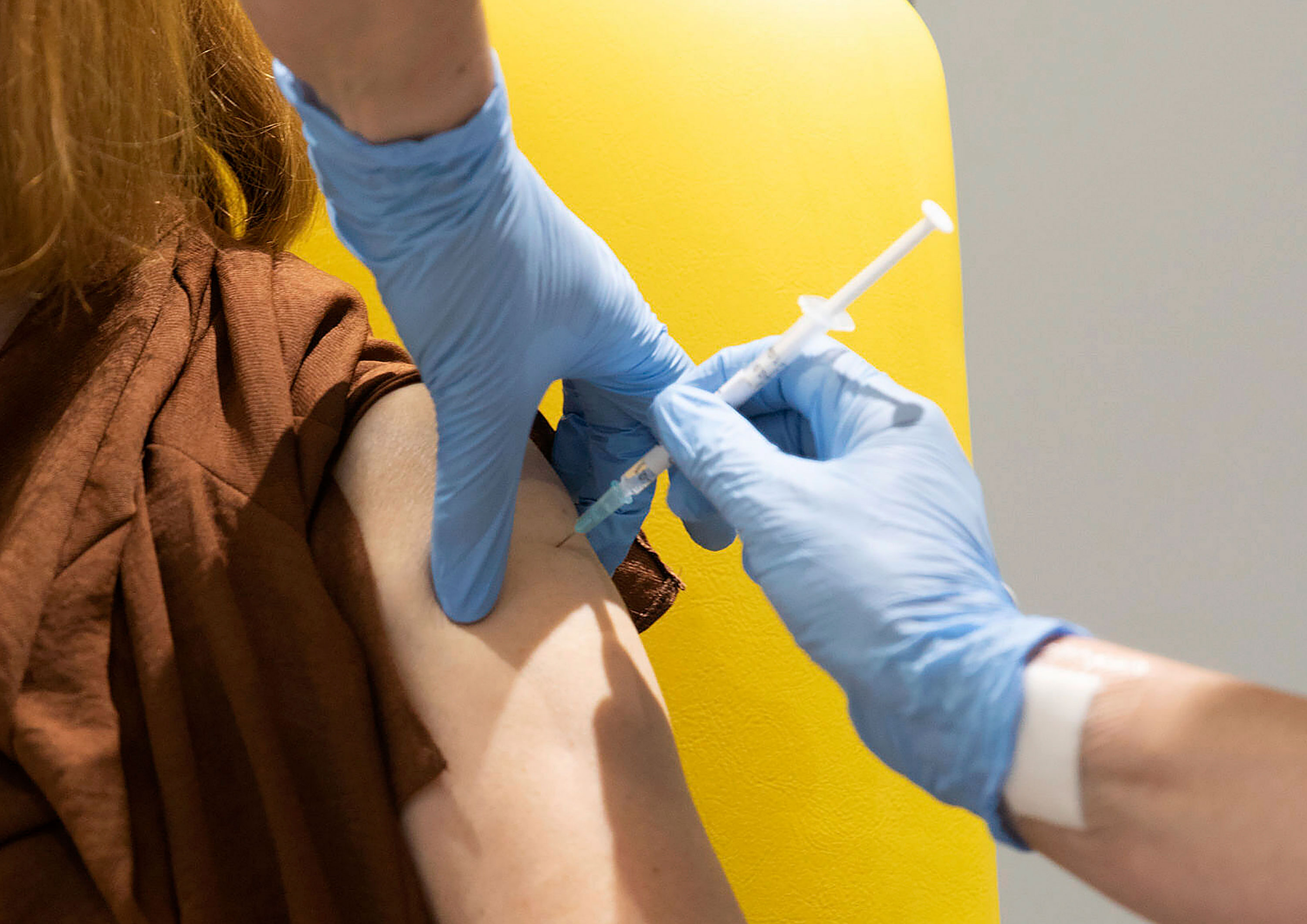 A trial volunteer in Oxford, England, is administered a coronavirus vaccine developed by AstraZeneca and Oxford University.