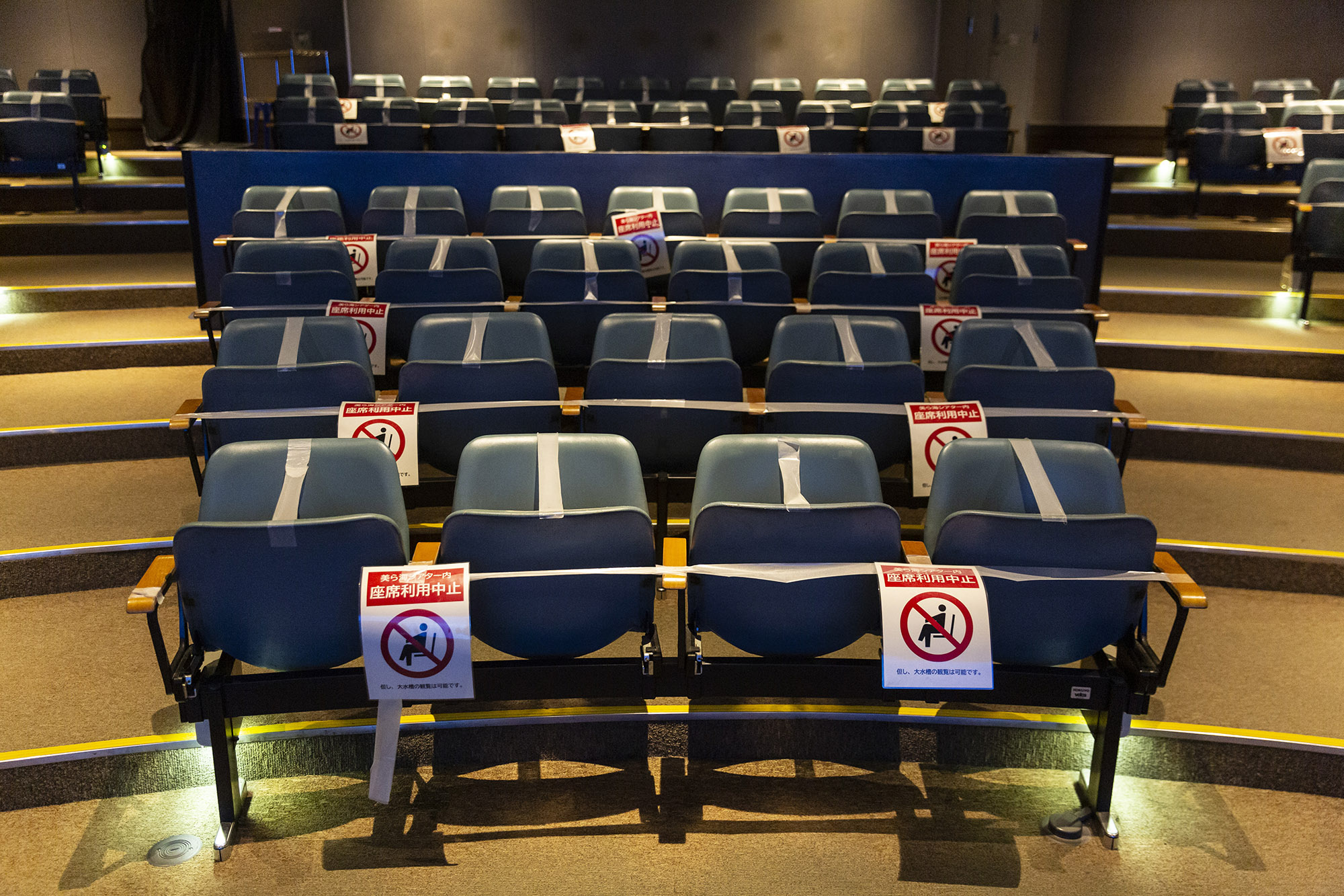 Notices are placed on seats in the Okinawa Churaumi Aquarium requesting that people don't sit down as a measure to protect against spreading coronavirus, on November 28, in Kunigami, Japan. 