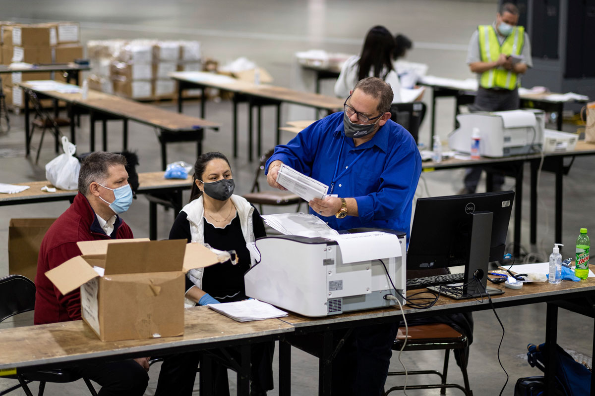 Workers scan ballots as the Fulton County presidential recount gets under way on November 25 at the Georgia World Congress Center in Atlanta.