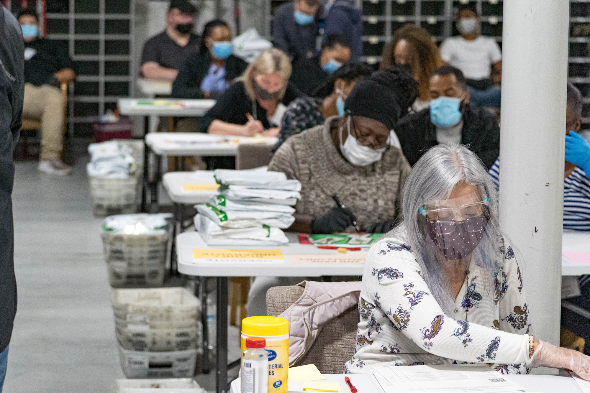 Gwinnett County election workers handle ballots as part of the recount for the 2020 presidential election at the Beauty P. Baldwin Voter Registrations and Elections Building on November 16 in Lawrenceville, Georgia. 