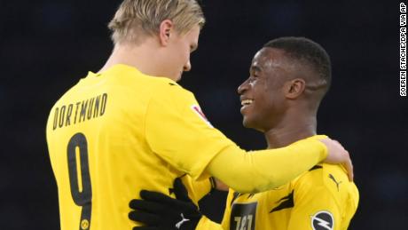 Haaland, left, and Moukoko hug each other after the end of the game against Hertha Berlin.