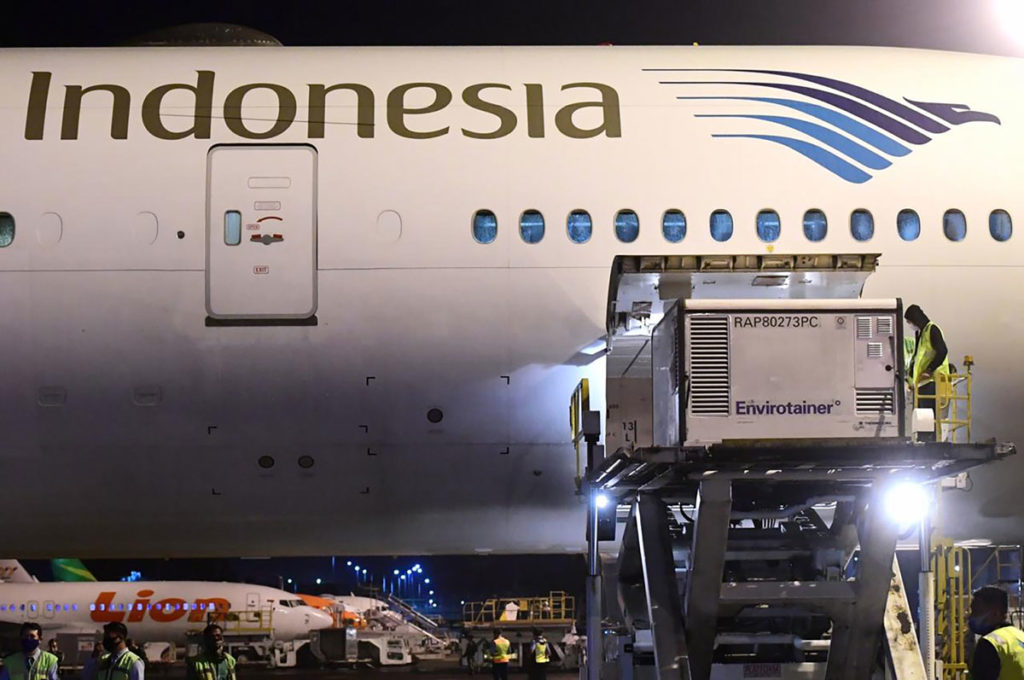 This handout photo taken on Dec. 6 and released by the Indonesian Presidential Palace shows workers unloading Sinovac Covid-19 vaccines at Jakarta International Airport, Indonesia.