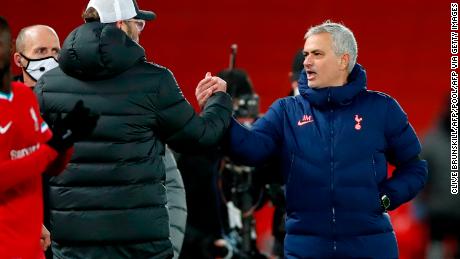 Jurgen Klopp shakes hands and exchanges words with Jose Mourinho after the match. 