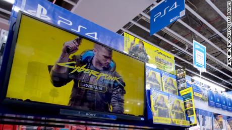 A screen shows a promotional video for &quot;Cyberpunk 2077&quot; in a store in Tokyo. Physical copies are still being sold.