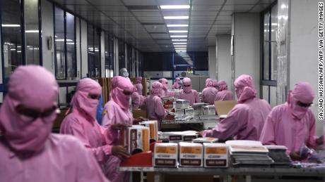 Workers pack syringes at the Hindustan Syringes factory, India&#39;s biggest syringe manufacturer, is ramping up production to churn out a billion units, anticipating a surge in demand.