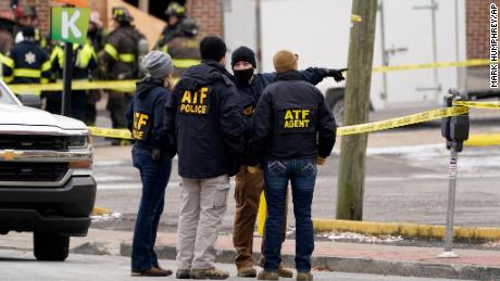 Emergency personnel work near the scene of the explosion Friday.