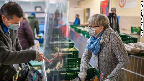 People receive fruit and vegetables from volunteers at a Tafel food bank in Schweinfurt, Germany in November.