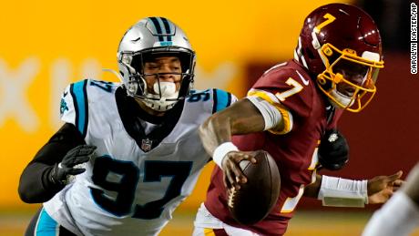 Washington Football Team quarterback Dwayne Haskins (7) runs away from Carolina Panthers defensive end Yetur Gross-Matos (97) on Sunday.