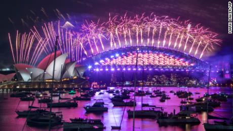 Fireworks explode over the Sydney Opera House and Harbour Bridge to ring in 2021. One million people would usually crowd the Sydney Harbor to watch the annual fireworks that center on the Sydney Harbour Bridge. But this year authorities advised revelers to watch the fireworks on television.