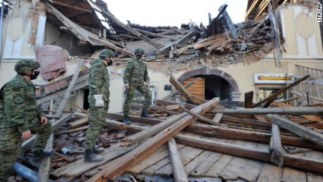 Soldiers inspect the destruction in Petrinja.