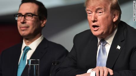 President Donald Trump speaks as US Secretary of the Treasury Steven Mnuchin looks on in St. Louis, Missouri on March 14, 2018. (MANDEL NGAN/AFP/Getty Images)