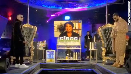 Before their Verzuz battle in November, Jeezy, left, and Gucci Mane stand on stage at Magic City as Stacey Abrams urges the audience to vote.