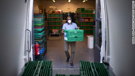 Co-founder and chair of the First Love foundation, Aerold Bentley loads crates packed with goods for distribution.