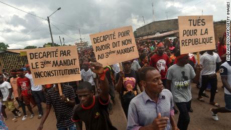 Demonstrators hold signs reading &quot;Beheaded for saying no to unconstitutional third term&quot; and &quot;Killed for the republic&quot; during a march to denounce the death of protesters who have been killed in poll-linked violence, in central eastern Daoukro, on November 21.
