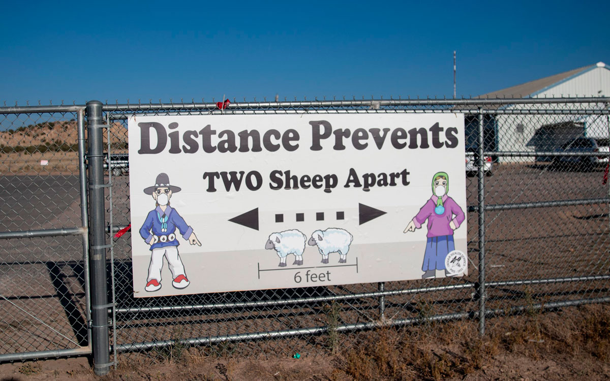 A sign encourages social distancing outside the Blue Gap Mini Store in Blue Gap, Arizona on Sept. 24.