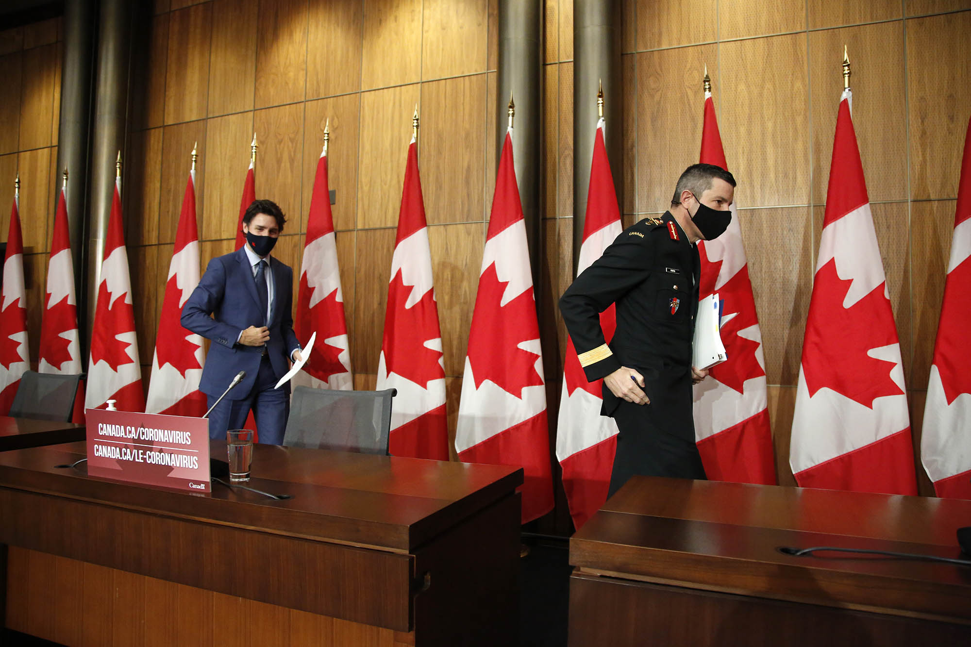 Canada prime minister Justin Trudeau, left, and Major General Dany Fortin, vice president of logistics and operations at Public Health Agency of Canada (PHAC), depart following a news conference in Ottawa, Ontario, Canada, on Thursday, December 10. 