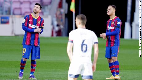 Messi and Dest stand for a minute of silence in tribute to Diego Armando Maradona during the La Liga match between Barcelona and Osasuna.
