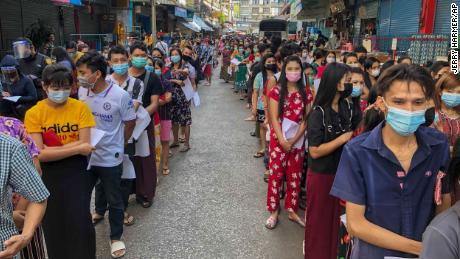 People stand in lines to get Covid-19 tests in Samut Sakhon, Thailand, on Sunday, December 20, 2020. 