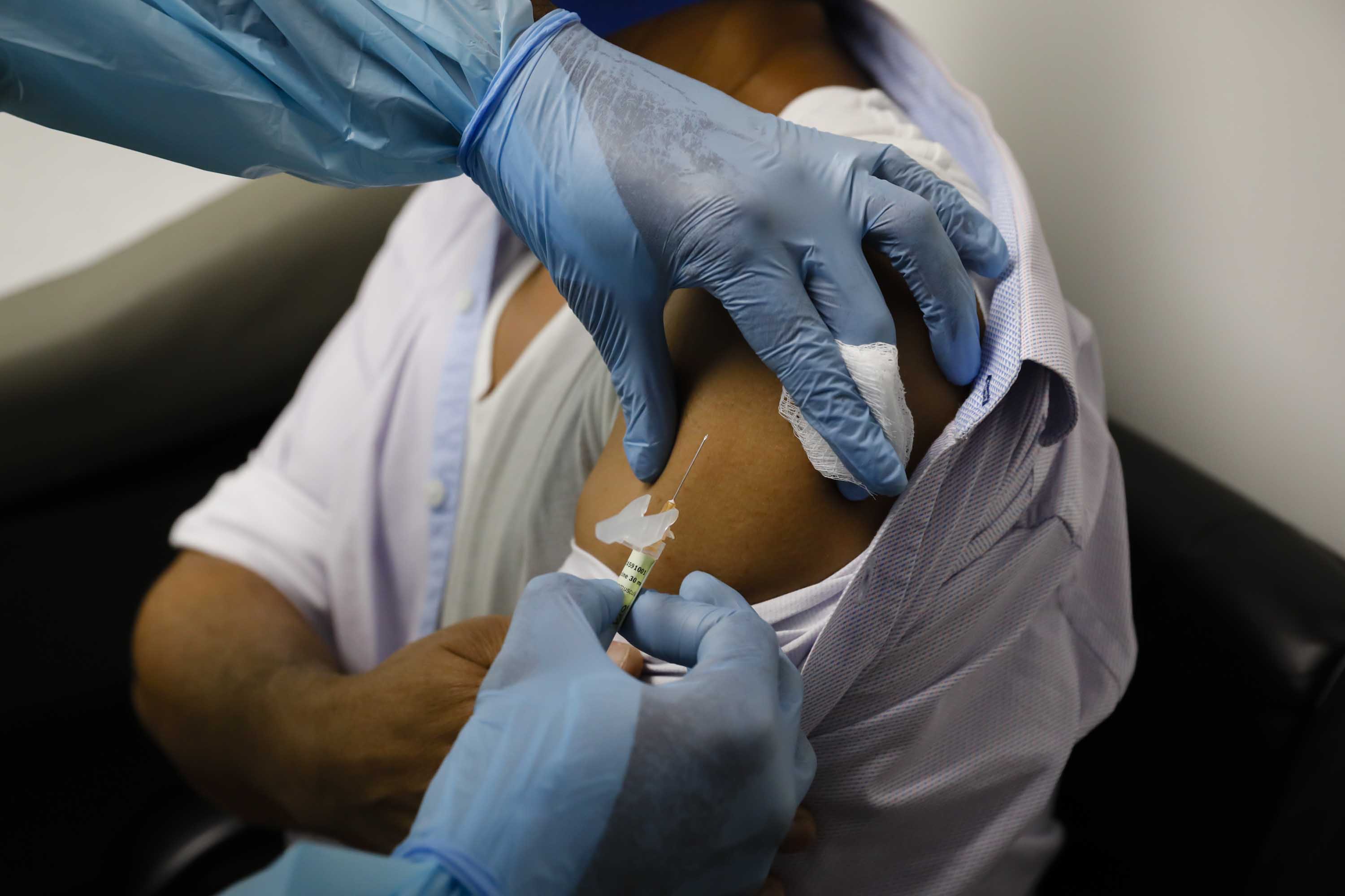 A health worker injects a person during clinical trials for a Covid-19 vaccine at Research Centers of America in Hollywood, Florida, on Sept. 9.