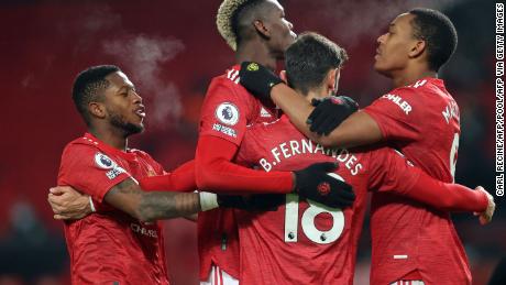Manchester United&#39;s Portuguese midfielder Bruno Fernandes celebrates with teammates after putting his side 2-1 ahead from the penalty spot against Aston Villa on Friday, January 1.