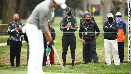 NBA athlete Stephen Curry of the Golden State Warriors takes a photo as Collin Morikawa of the United States putts on the seventh green during the final round of the 2020 PGA Championship.