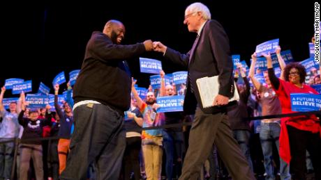 Rapper Killer Mike and Democratic presidential candidate Sen. Bernie Sanders, I-Vt., fist bump at the start of a campaign rally in Columbia, S.C., Friday, Feb. 26, 2016, the day before the South Carolina Democratic Primary. 