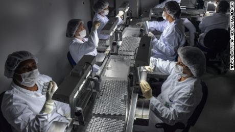 Employees work on the production line of CoronaVac, Sinovac Biotech&#39;s vaccine against Covid-19 coronavirus at the Butantan biomedical production center, in Sao Paulo, Brazil, on January 14, 2021. 
