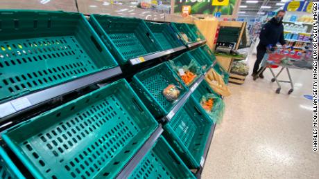 A supermarket customer looks at  near empty shelves in a supermarket in Belfast, Northern Ireland earlier this month.