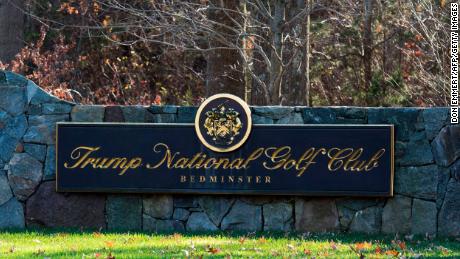 A sign on the stone wall greets visitors to the Trump National Golf Club.