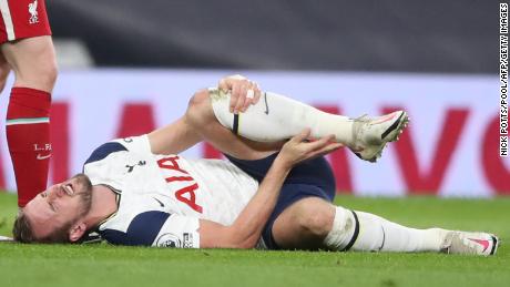 Kane lies on the pitch with an apparent injury during the game against Liverpool.