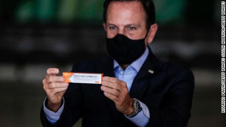 Sao Paulo Gov. Joao Doria holds a box of Sinovac&#39;s Coronavac vaccine during a news conference on November 19, 2020 in Sao Paulo, Brazil.