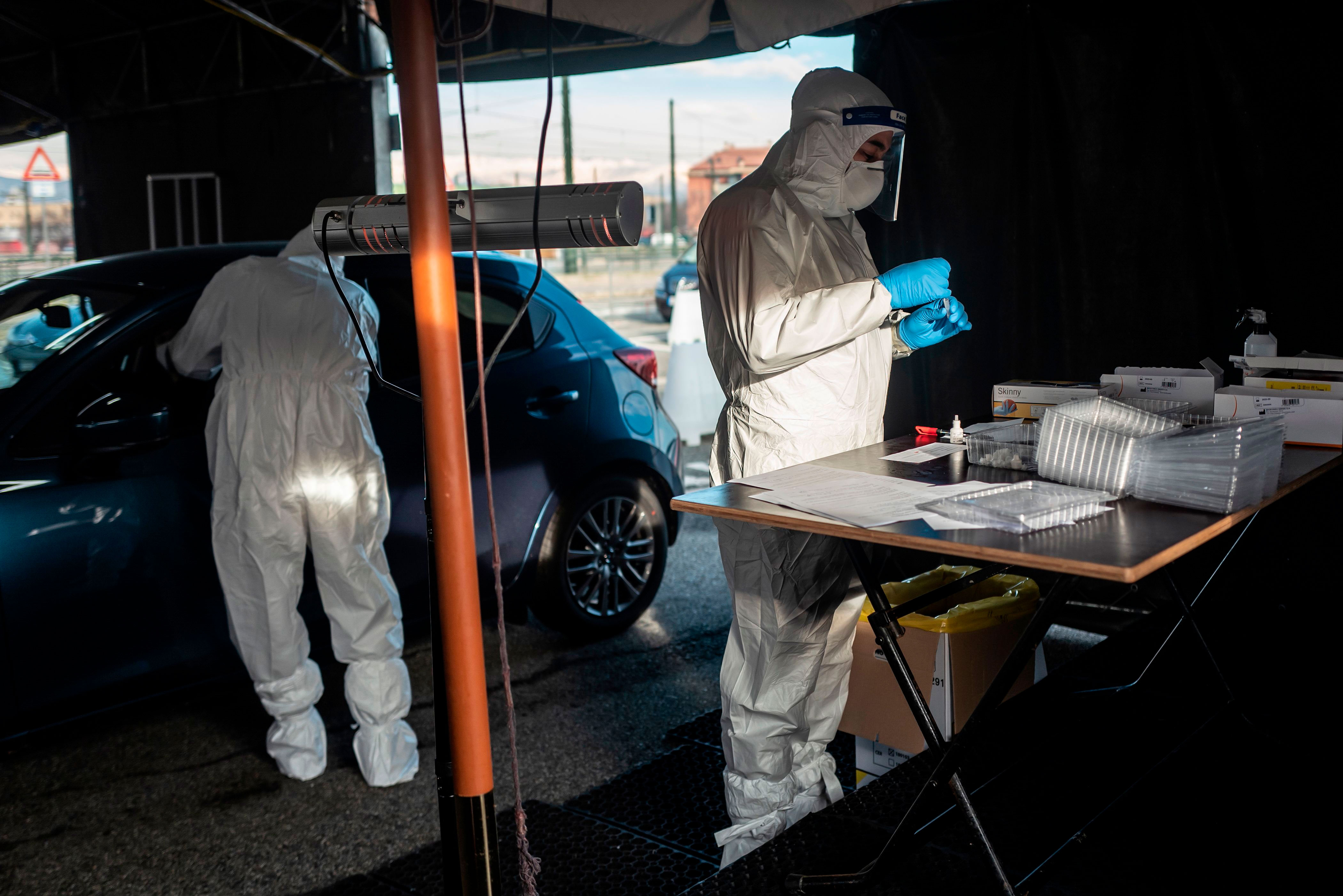 Military medical workers collect swab samples at a drive-thru Covid-19 testing center in Turin, Italy, on January 12.