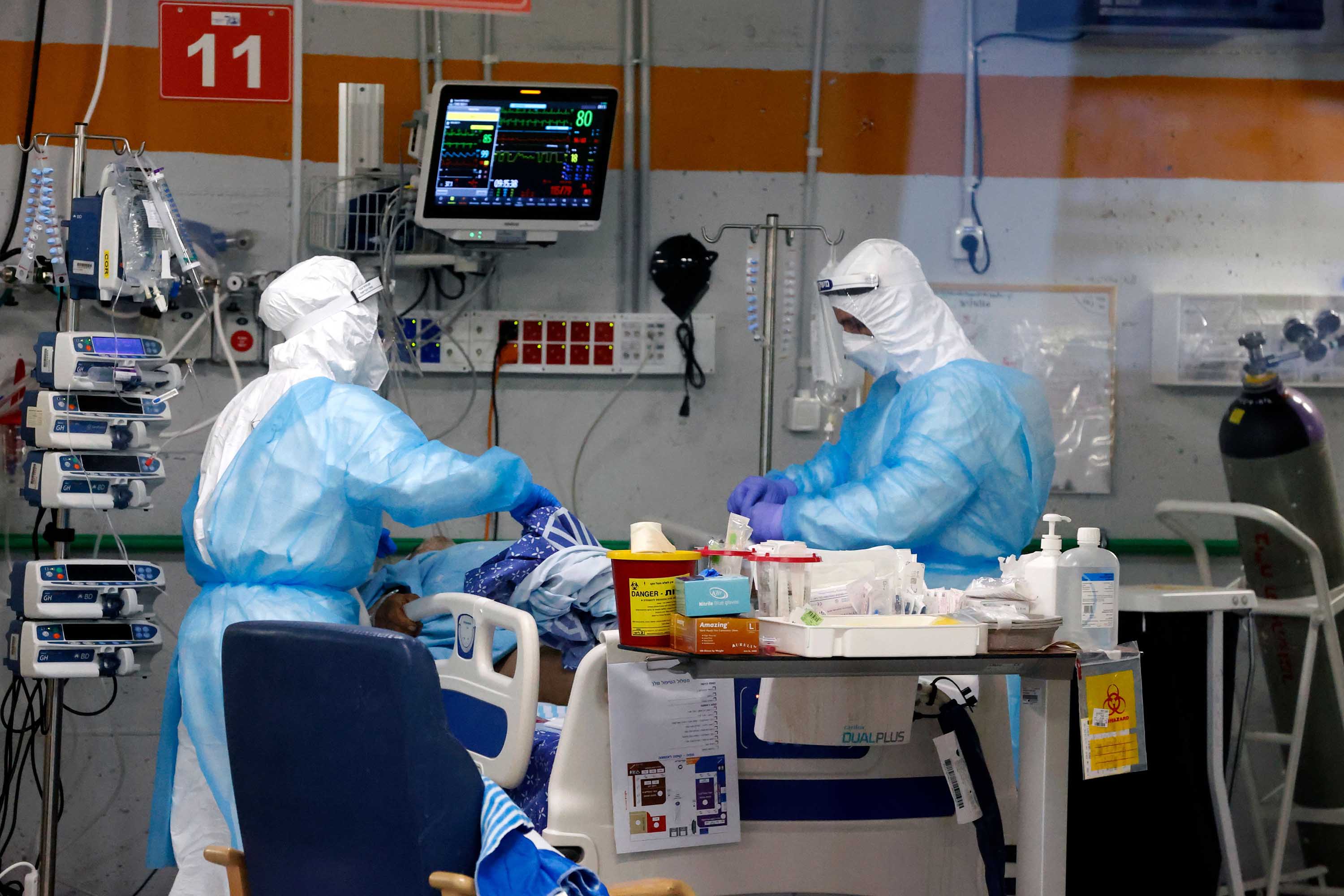Medics care for a COVID-19 patient at the Sheba Medical Center's isolation ward, in Ramat Gan, Israel, on January 18.