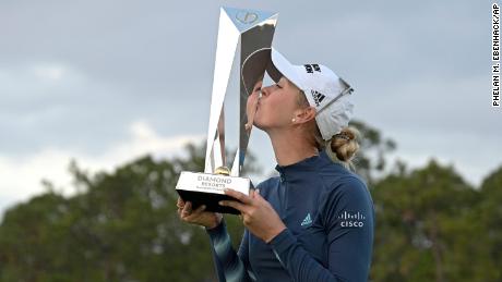 Jessica Korda kisses the championship trophy after winning the playoff against Danielle Kang.