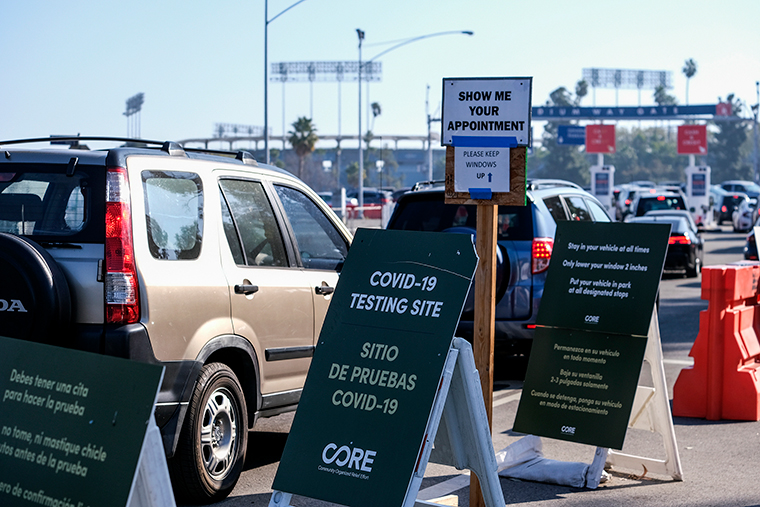 Motorists wait in long lines to take a coronavirus test in a parking lot at Dodger Stadium on Monday, January. 4, in Los Angeles. 
