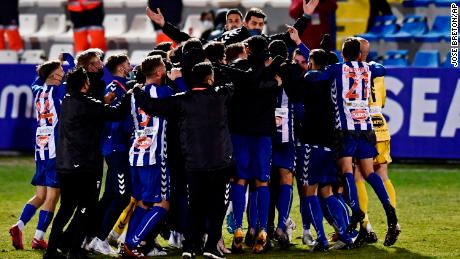 Alcoyano players celebrate after knocking out Real Madrid.