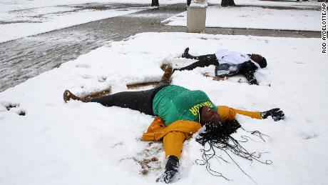 Baylor University students make snow angels after at least five inches was reported throughout Central Texas on Sunday.