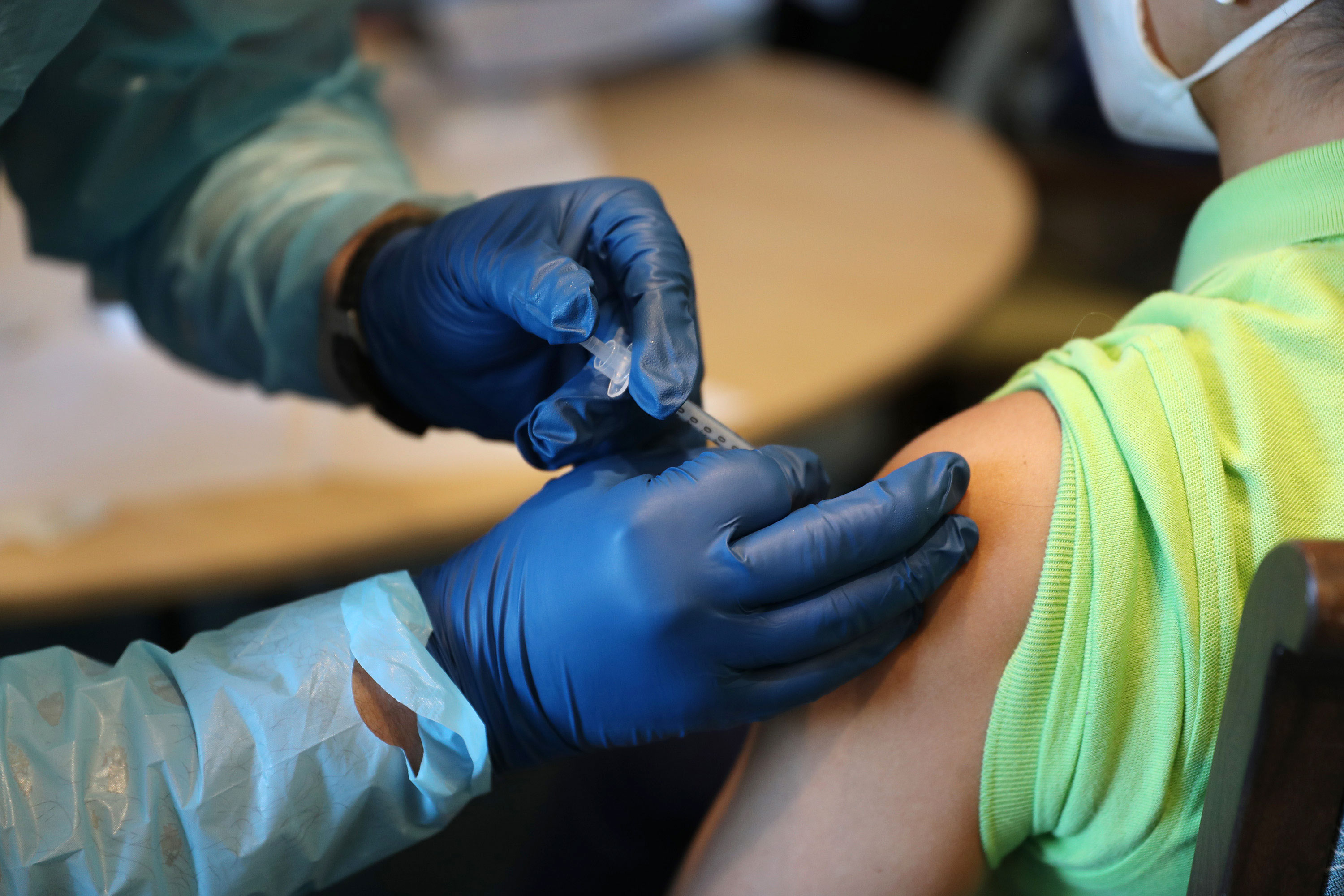 A health care worker administers a Pfizer/BioNTech Covid-19 vaccine in Pompano Beach, Florida, on January 6.
