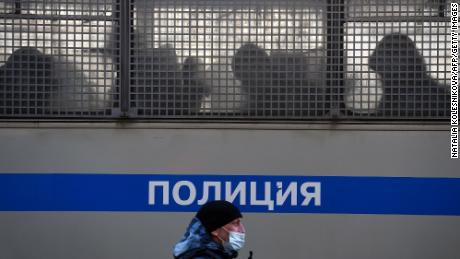 Silhouettes of detained people are seen in a police truck near the Moscow City Court.