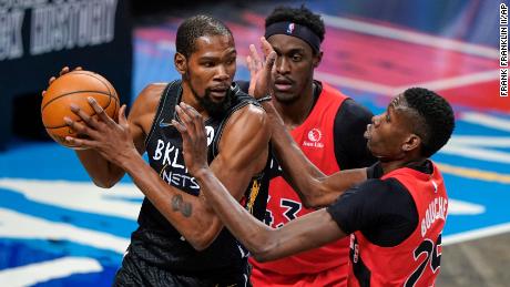 The Raptors&#39; Pascal Siakam and Chris Boucher defend against Durant.