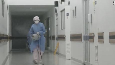 Member of the medical team disinfects the hallways at the Cardiovascular Hospital in Soacha, Colombia.