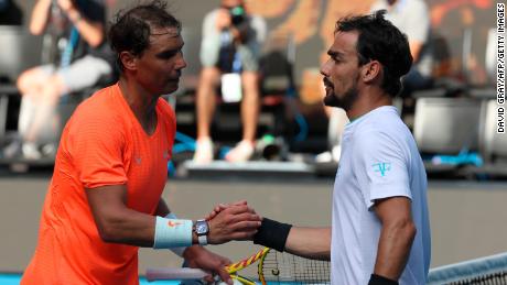 Nadal (left) shakes hands with  Fognini after their men&#39;s singles match.