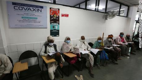 Vaccine trial volunteers wait for a dose of Covaxin at the People&#39;s Hospital in Bhopal on December 7, 2020. 