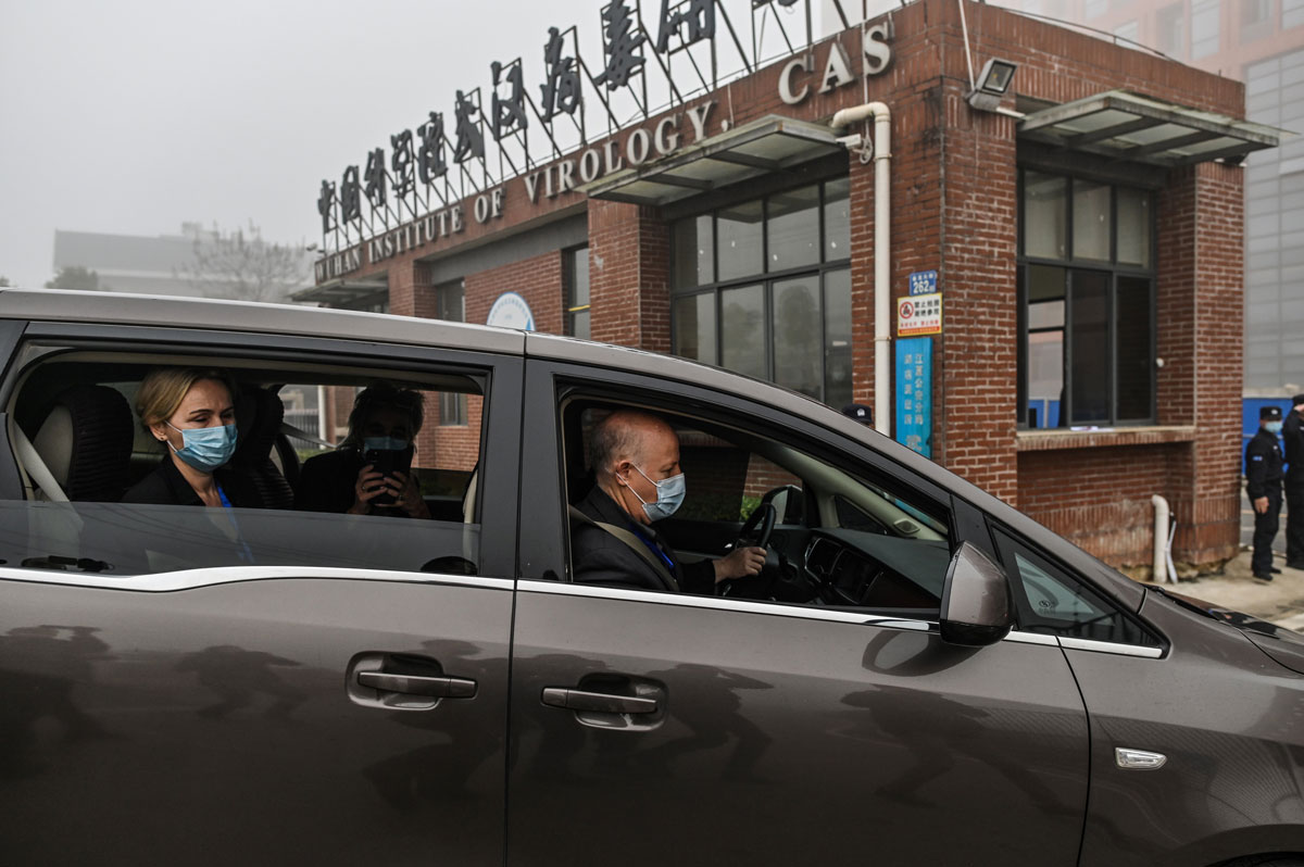 Peter Daszak (R), Thea Fischer (L) and other members of the World Health Organization team investigating the origins of Covid-19 arrive at the Wuhan Institute of Virology in China's central Hubei province on February 3.